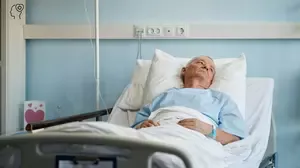 Man lying in hospital bed recovering from severe injury, illustrating the psychological impact of catastrophic injury and trauma recovery
