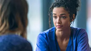 Healthcare worker calmly listening to a distressed patient, illustrating conflict escalation in healthcare settings.