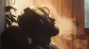 A man listening to music with headphones, illustrating how music and memory evoke emotion, reflection, and personal identity.