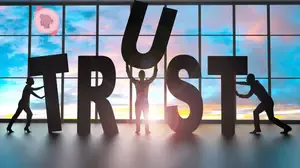 Silhouetted figures supporting large letters spelling trust, symbolising psychological safety, reliability, and being supported by others