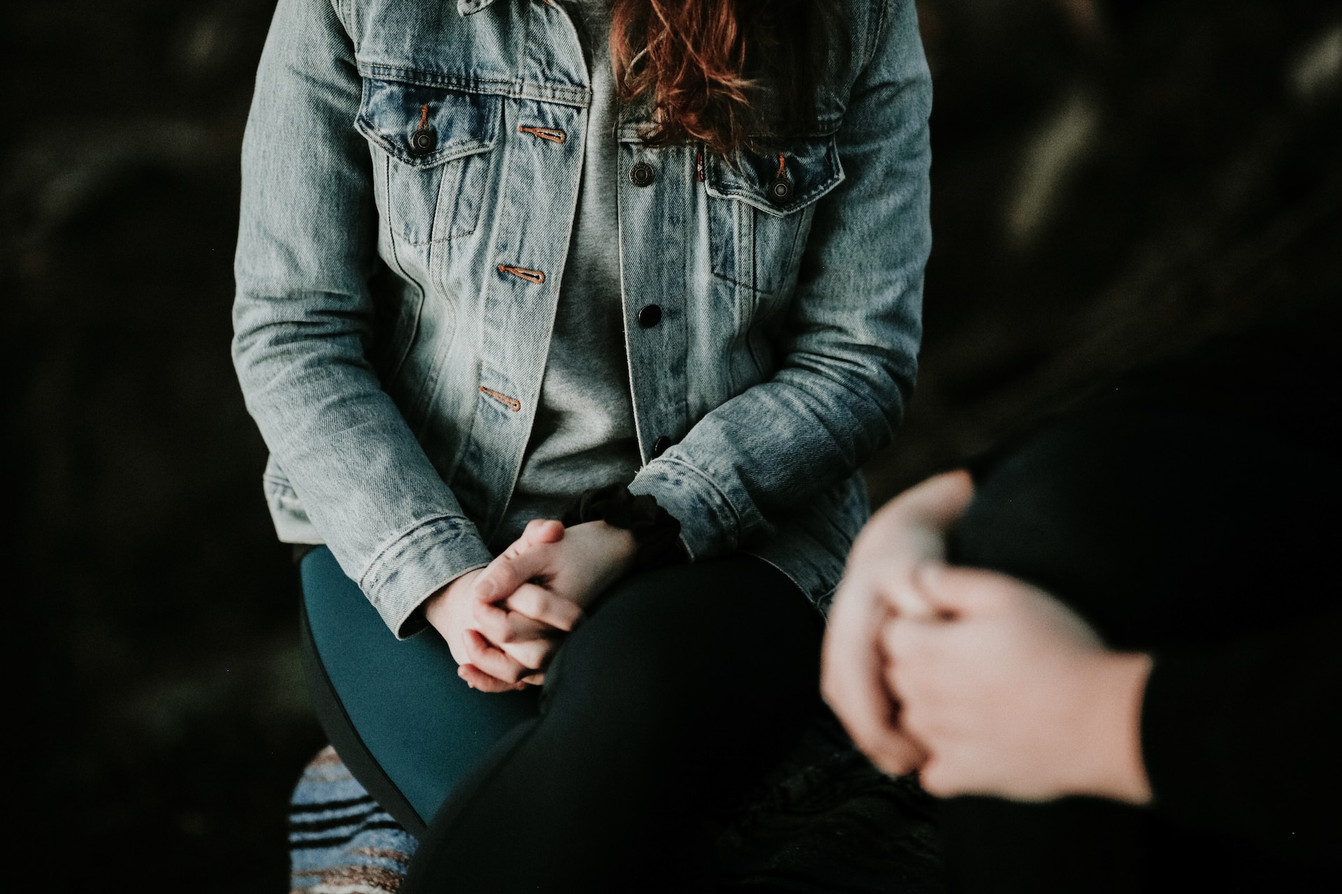 woman wearing gray jacket in a psychotherapy session.