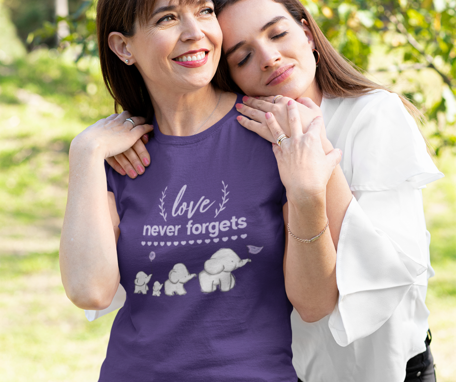 Mother wearing purple Alzheimer's and Brain Awareness T-Shirt, being hugged by daughter.