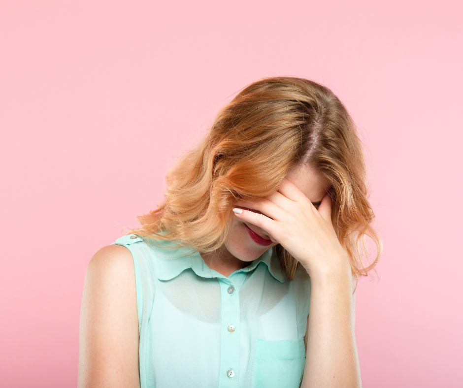 Young woman looking embarrassed.