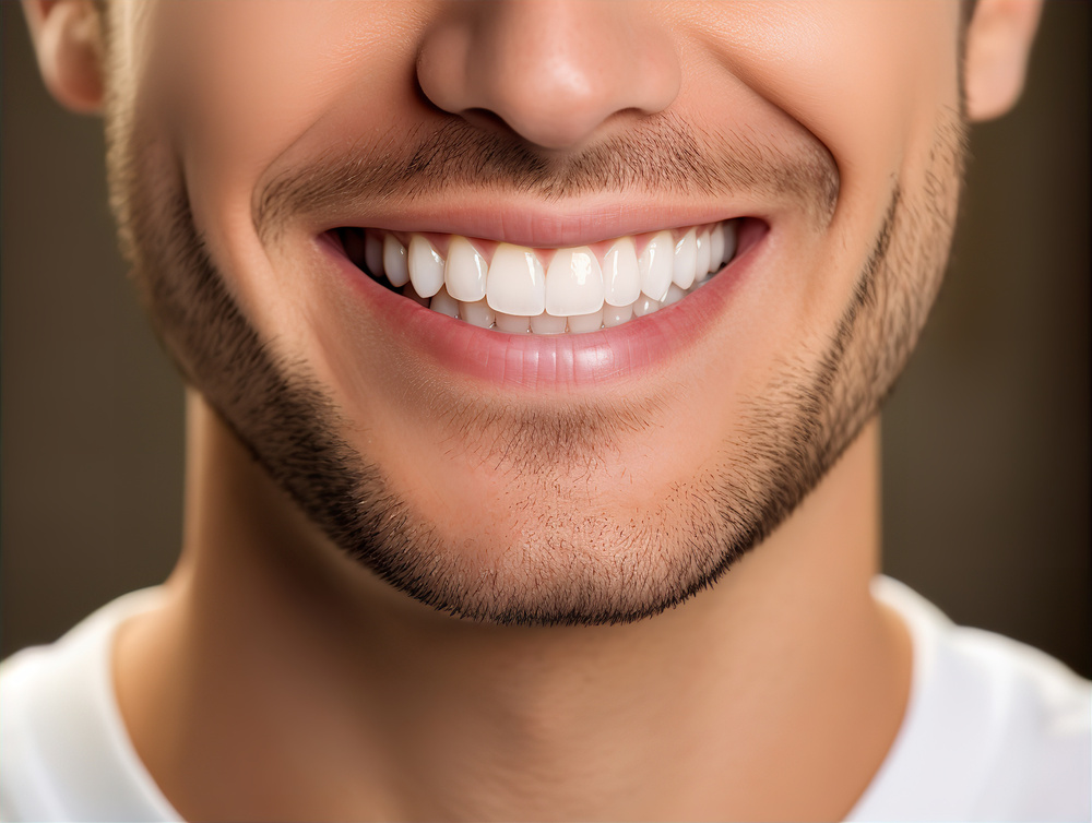 Cropped headshot of confident young man smiling