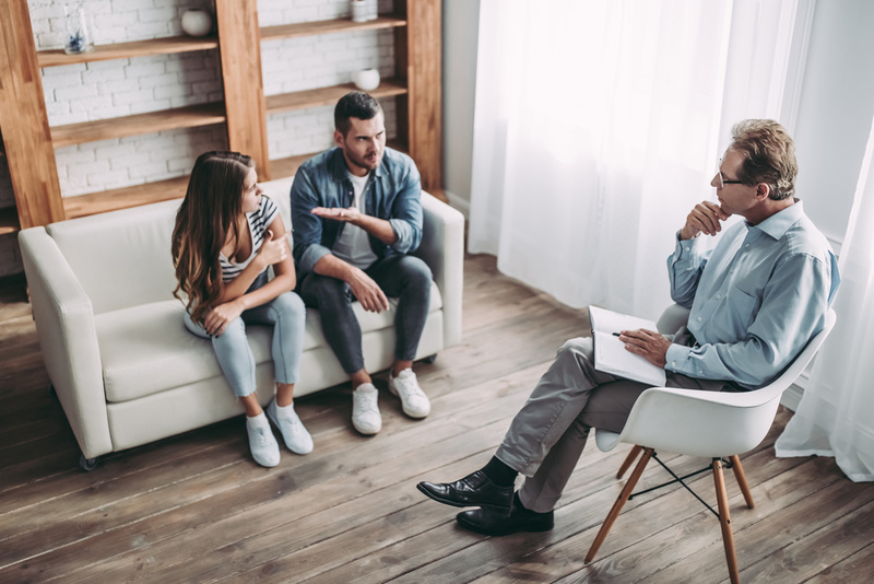 Young couple having relationship counseling with a psychologist.