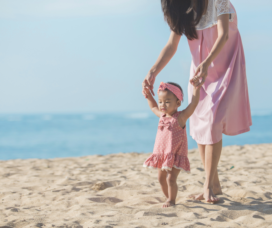 Mother teaching baby to walk.