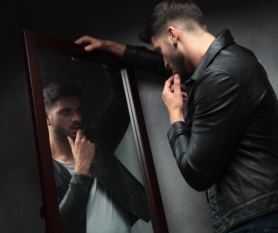 young narcissist looking in mirror