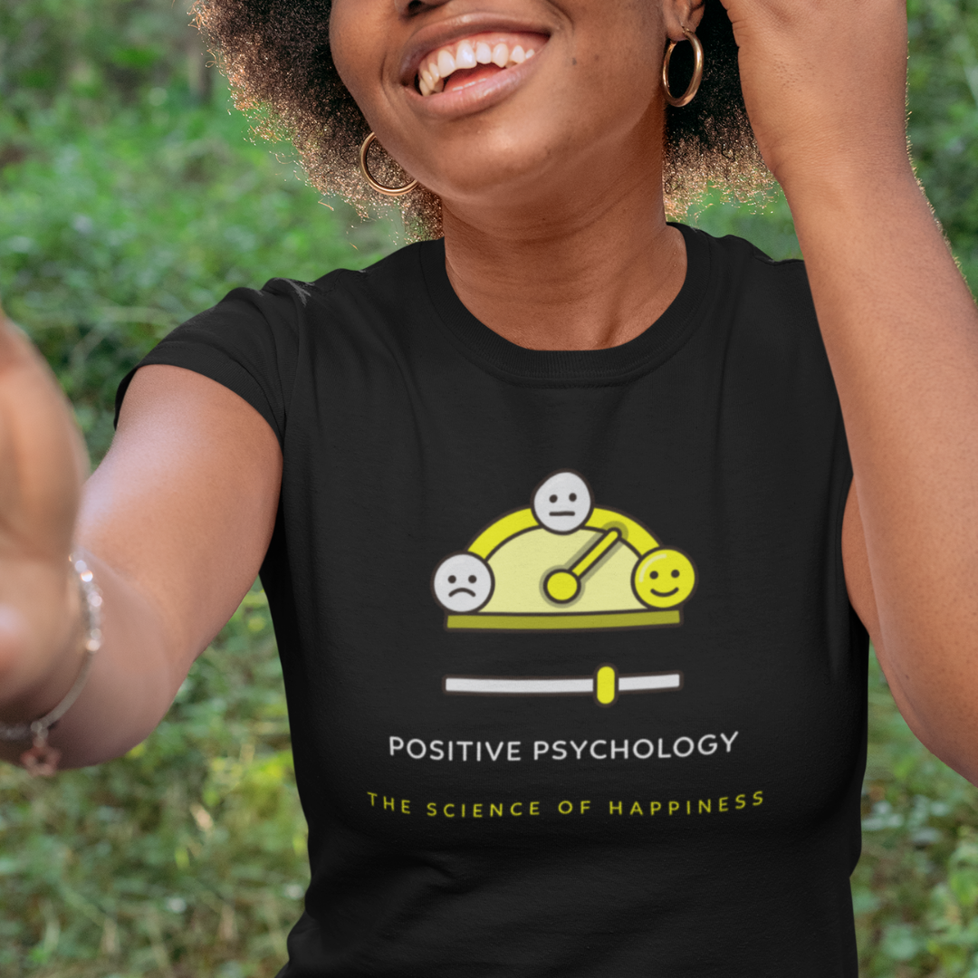 Smiling woman wearing positive psychology t-shirt.