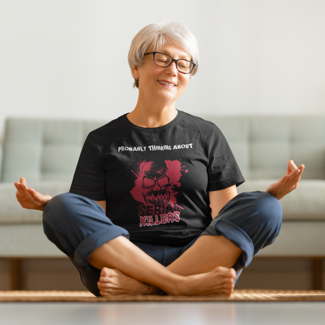 Mature woman meditating wearing a Probably Thinking About Serial Killers T-Shirt.