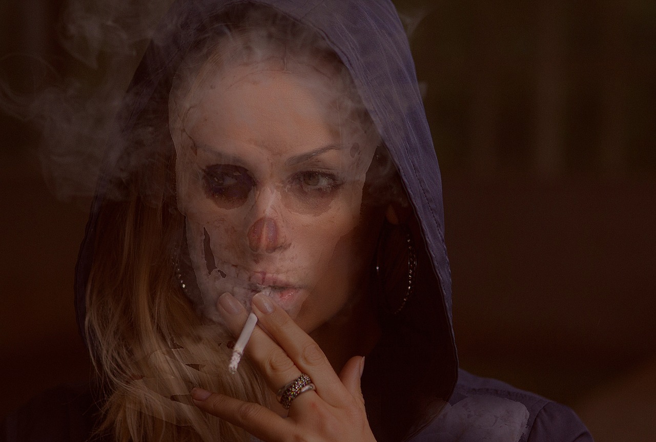 Woman smoking with skull like appearance.