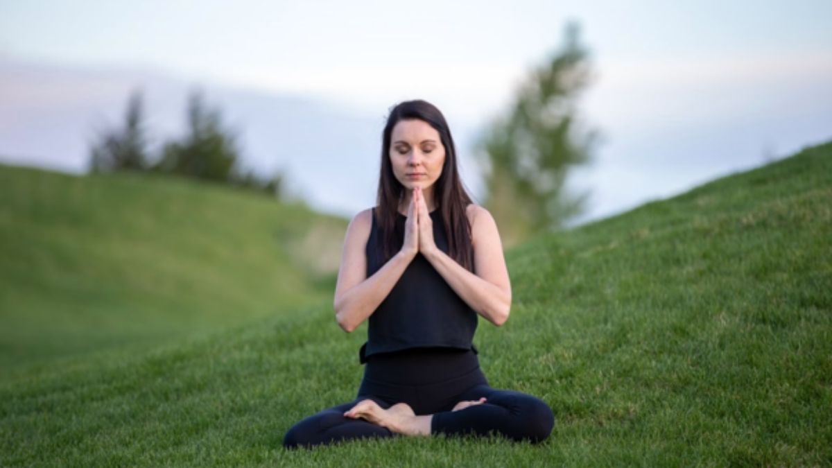 Woman practicing mindfulness outdoors, illustrating how to stay calm during change and uncertainty. Woman practicing mindfulness outdoors, illustrating how to stay calm during change and uncertainty.