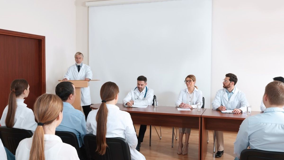 Group of healthcare executives in a small-room meeting listening to speakers during an executive healthcare conference focused on collaboration and strategy. Group of healthcare executives in a small-room meeting listening to speakers during an executive healthcare conference focused on collaboration and strategy.