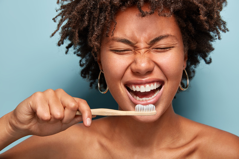 Self confident woman brushing her teeth
